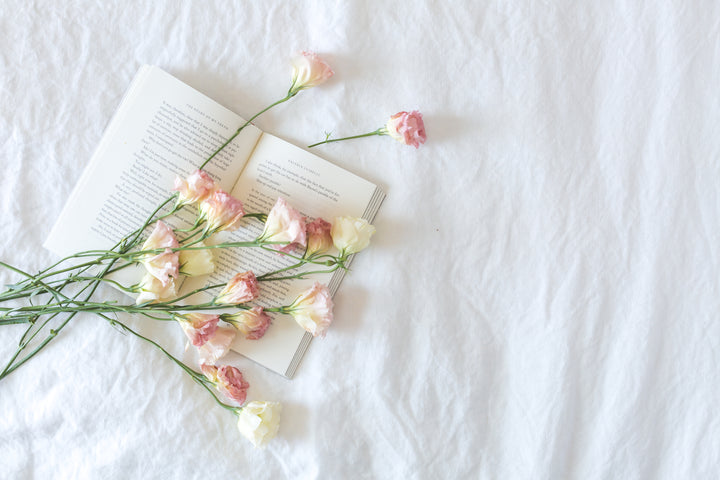 files/bed-with-book-and-flowers.jpg
