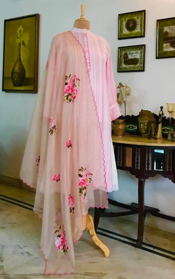 it’s a 4 piece fully stitched and comes with a Victorian inspired inner/slip done in pure | mulmul . The Kurta is in crepe linen. Finished with a delicate hand scalloping and lace finishing on on the flounced sleeves. It comes with a peach pink farshi in modal cotton which has temple scalloping on the ends and a Kota doria nude coloured dupatta which has again been hand scalloped and had hand done appliqué Roses all over. Mulmul And More by Priyanka Bhambry 