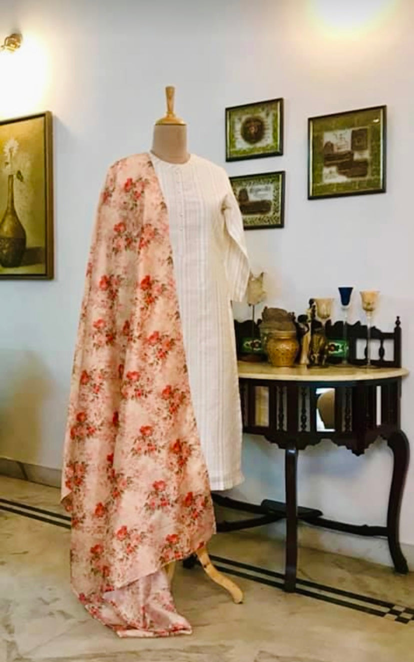 It’s a fully stitched and fully lined 3 piece suit set. The kurta is done in linen which has delicate gold sequence running in the weave. The pants are done in pure silk chanderi. The suit is lined with fine | mulmul. The pure silk cotton dupatta has a dreamy rose print and is embellished with our statement hand done latkans. Mulmul And More by Priyanka Bhambry